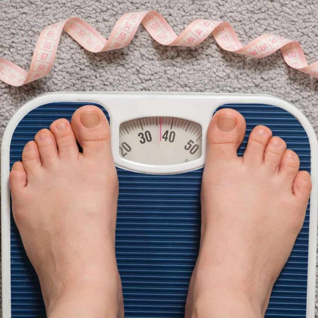 What is Binge Eating Disorder Person Standing on Scale